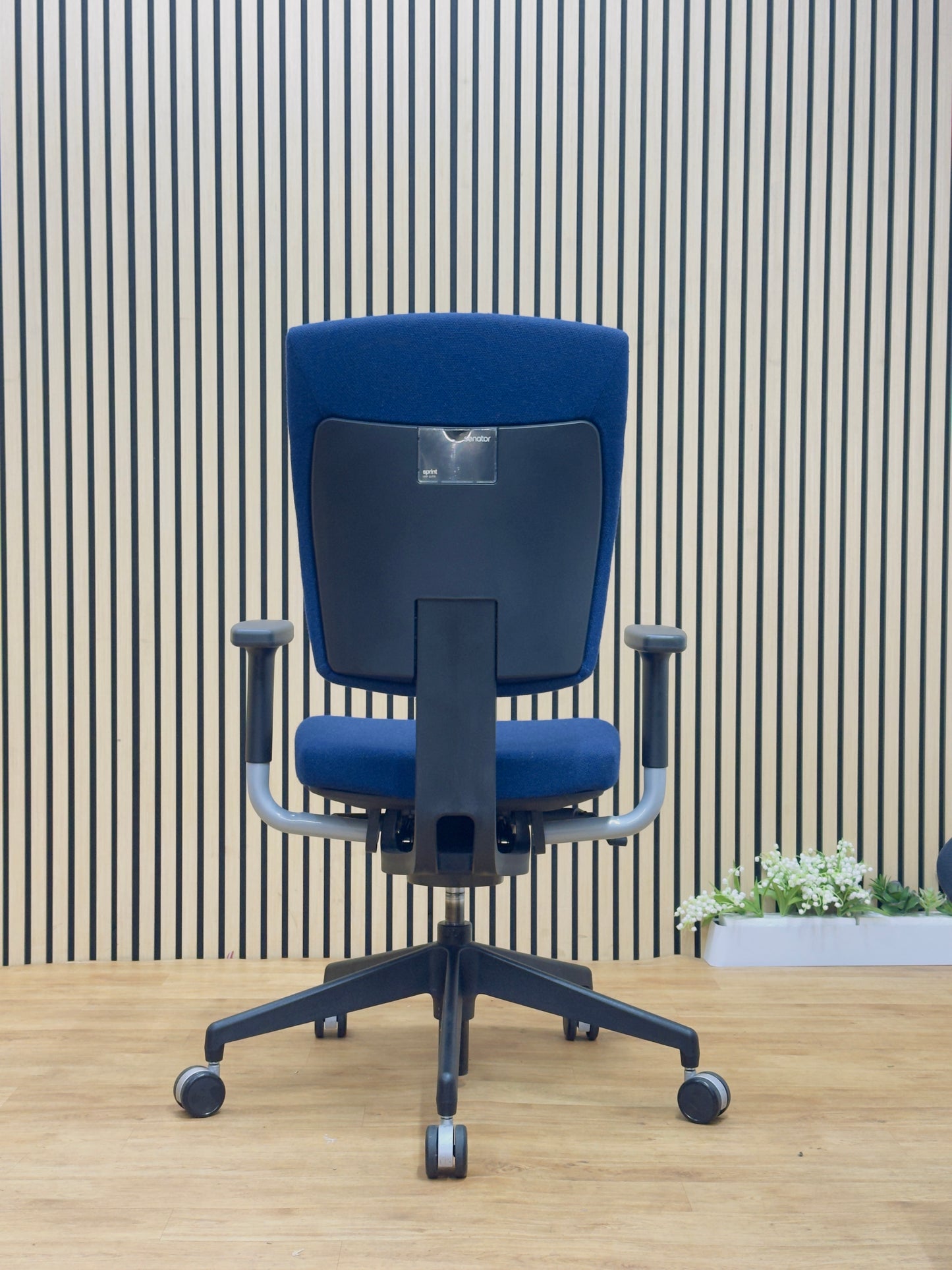 Back view of the refurbished Senator Sprint task chair showing the supportive frame and dark blue upholstery.