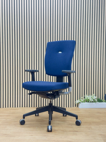 Dark blue Senator Sprint task chair set up at a modern wooden desk in a corporate office environment.