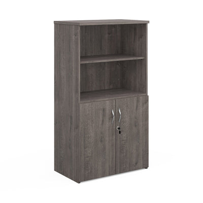 A grey oak wood combination unit with open top bookcase and two lower doors with silver handles.